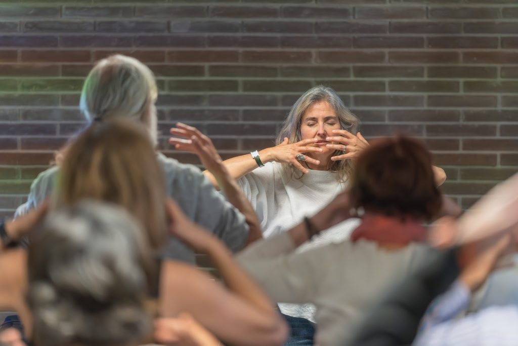 Meditation guidance with a group of elderly people. Mental health concept.