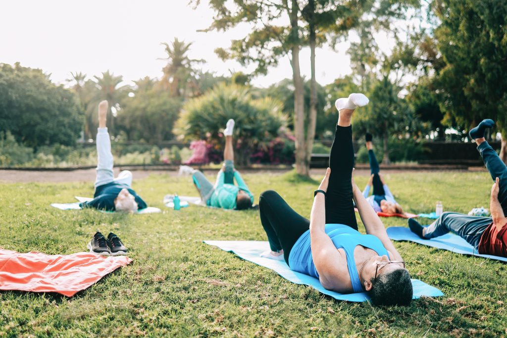 Sport, Senior people doing yoga training at park city. Elderly friends community, fitness concept